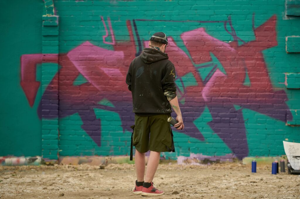 Creative male graffiti artist with paint