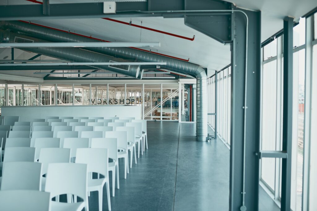 Shot of an empty office filled with chairs and surrounded with glass windows on the sides